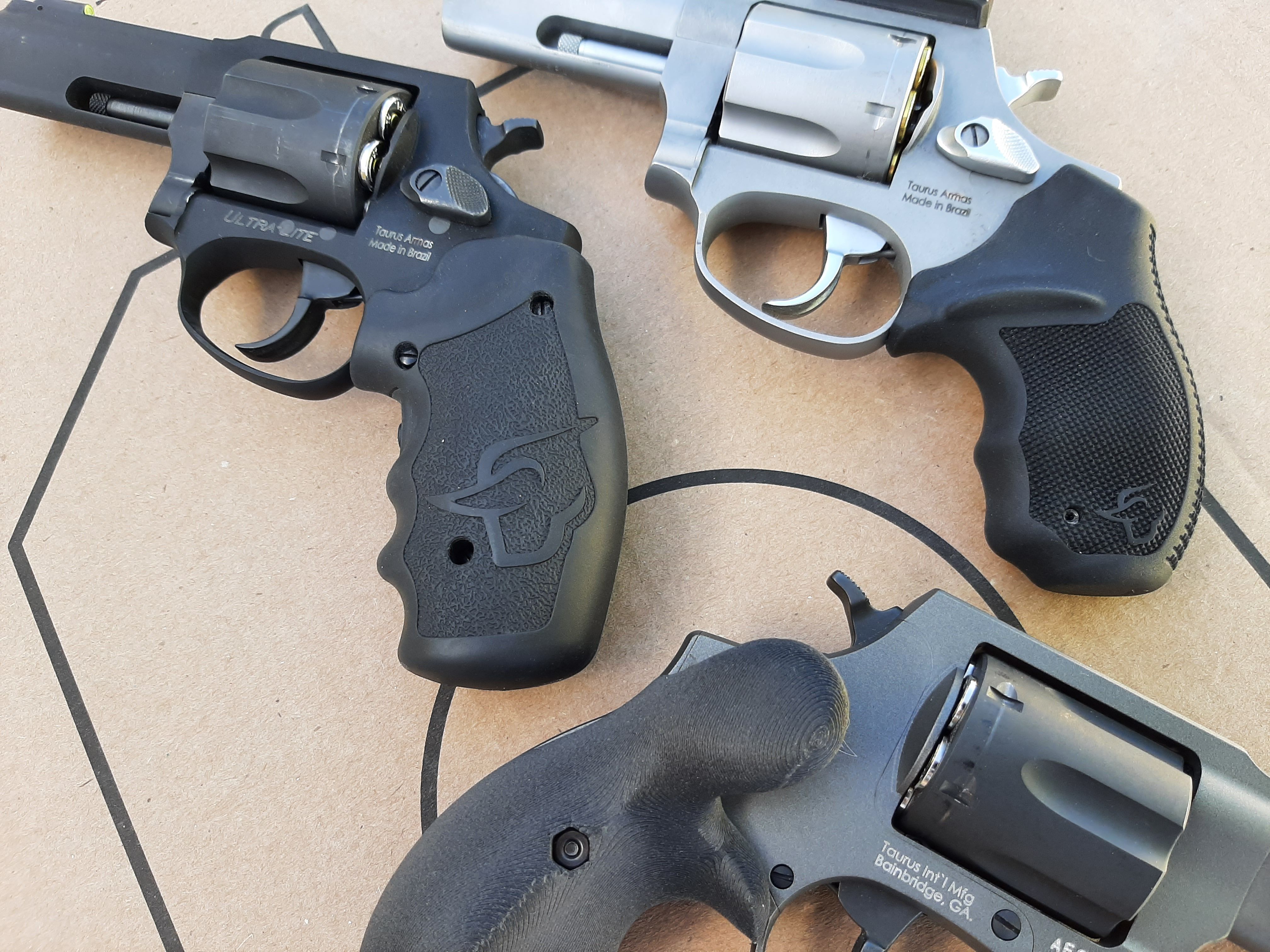 Revolvers allow you to tailor the grips to the mission. Hamre Forge’s “Hamre Hook” at bottom, Viridian’s laser grips in the center, Taurus factory small rubber grip at the top.